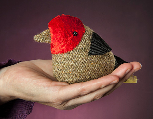 Bird puppet in sitting on a hand