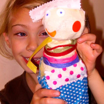 Child holding handmade puppet